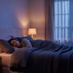 A woman sleeps peacefully in a cozy bedroom at night, bathed in soft warm light from lamps and cool light from a window.